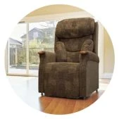 A comfortable, brown fabric riser recliner armchair in a bright living room setting.