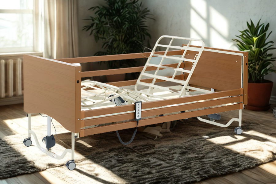 ICON Active Medical Bed with wooden headboard and adjustable profiling base in a bright room.