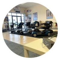 Interior view of a Bush Healthcare mobility showroom, featuring various mobility scooters and powerchairs on display.
