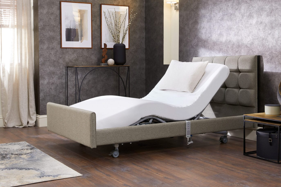 Opera Signature Comfort Profiling Bed with a high upholstered headboard and adjustable mattress in a modern bedroom.