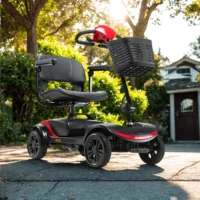 Bush S1 Pavement Mobility Scooter in red and black, parked on a driveway with a house in the background.