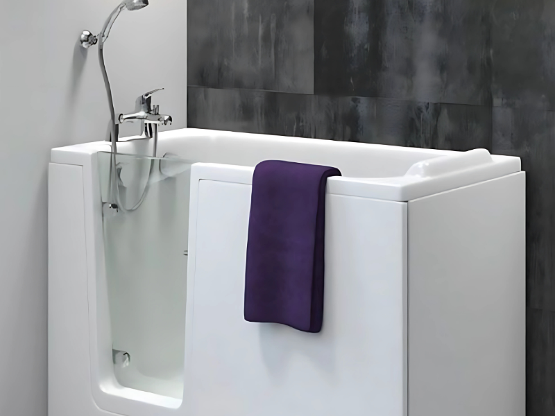 A modern walk-in bath with a sleek, clear glass door and a comfortable seat, perfect for safe and easy access.