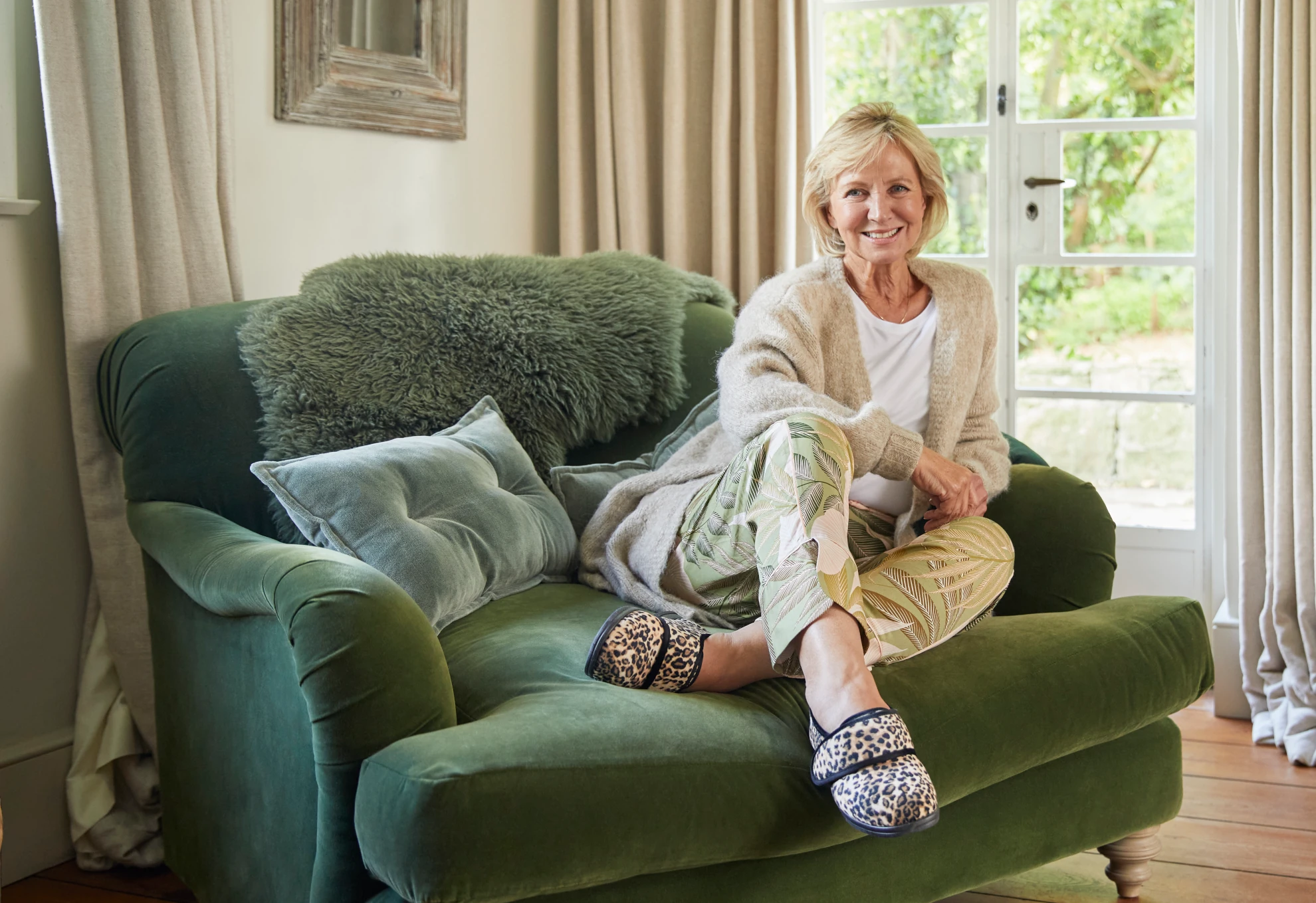 Woman relaxing in an armchair wearing Cosyfeet slippers
