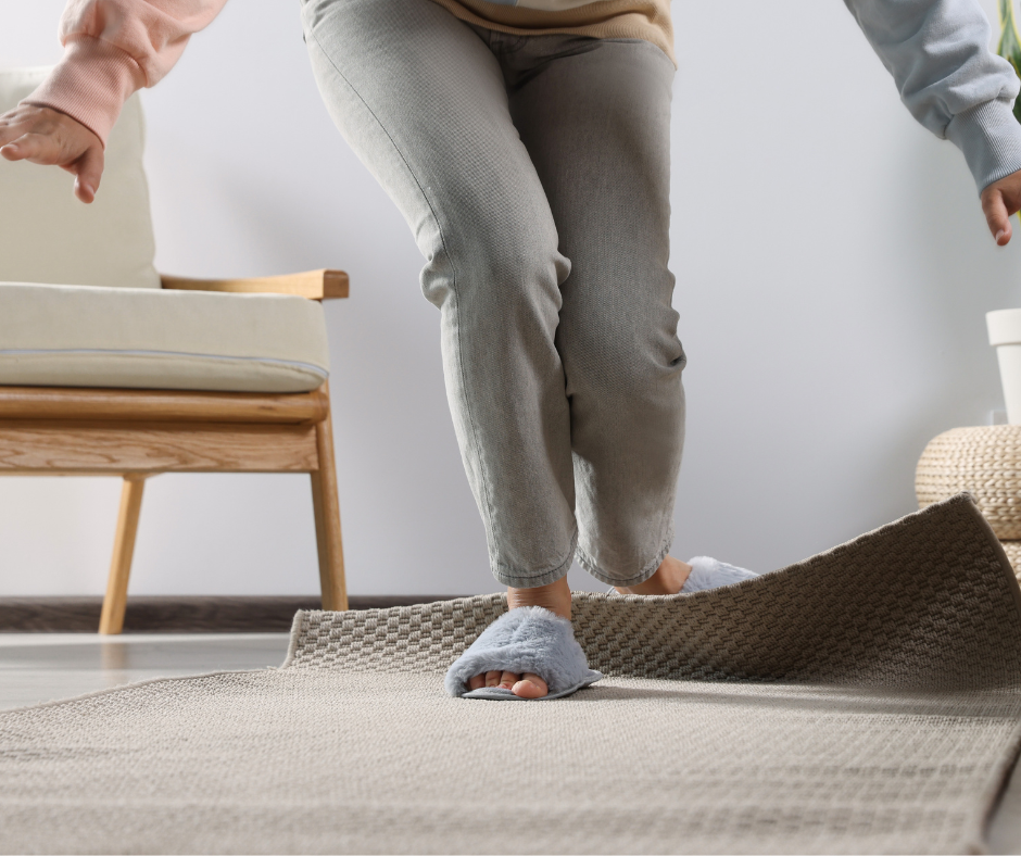A person tripping over a floor rug.