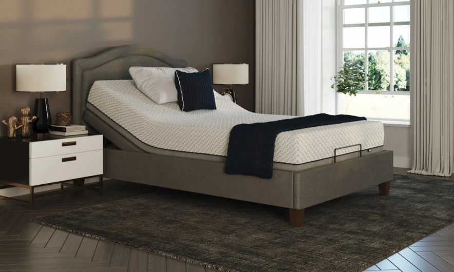 Single Opera Flyte Adjustable Bed with the head section elevated, featuring a distinct textured mattress and dark grey upholstered base in a stylish bedroom.