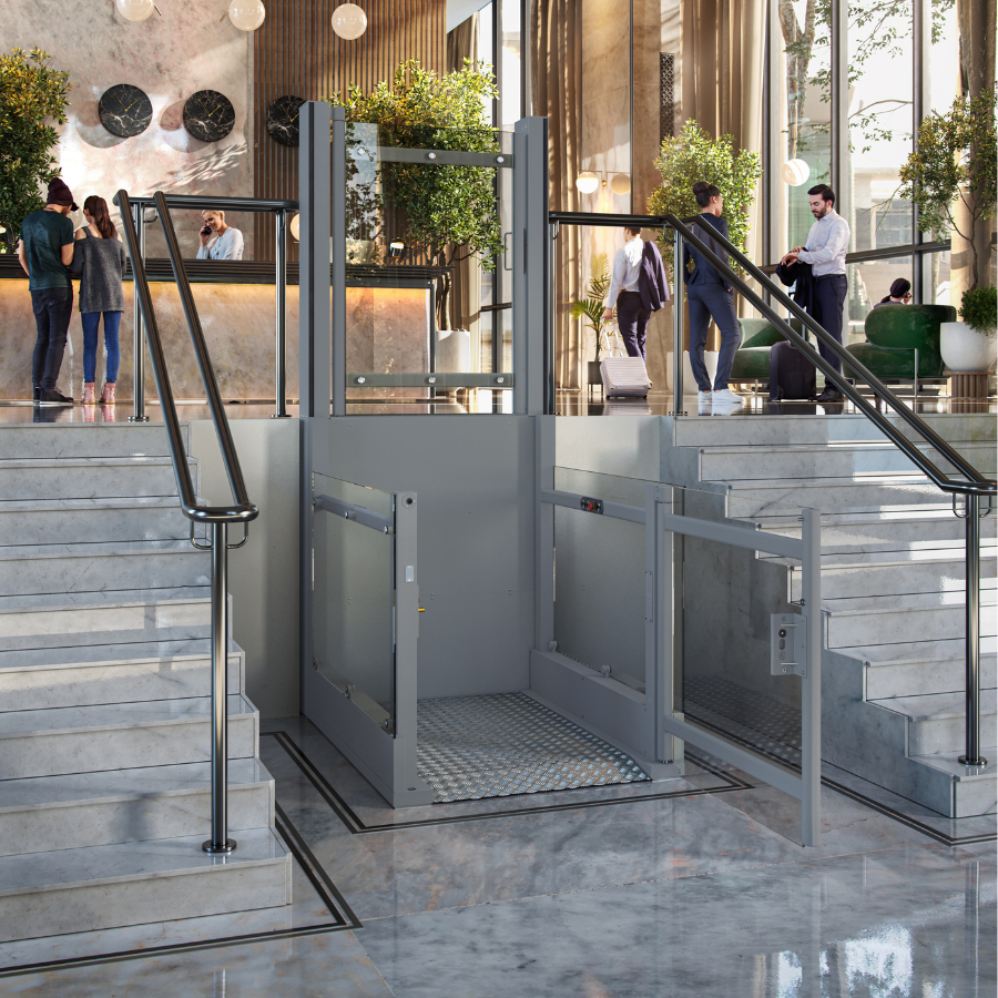 ilver Pollock Steplift Outdoor vertical platform lift installed between a brick wall and outdoor steps, clearly demonstrating a 2 metre rise installation for safe home access.