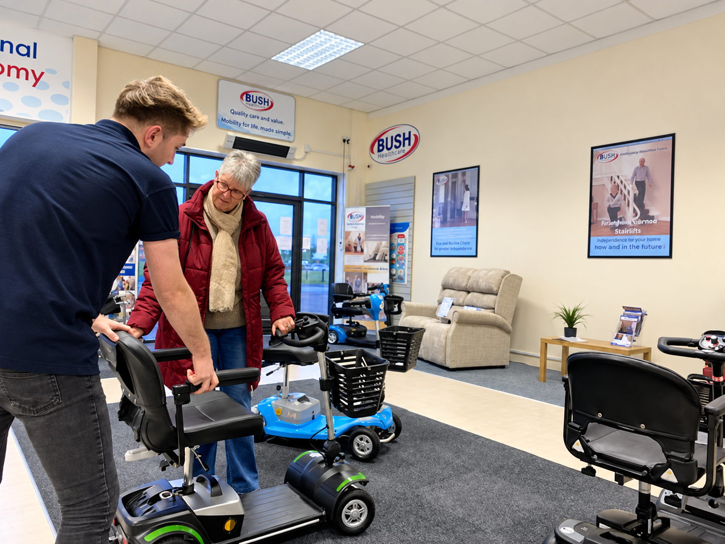 Bush Healthcare staff showing a customer a mobility scooter in the Swansea store