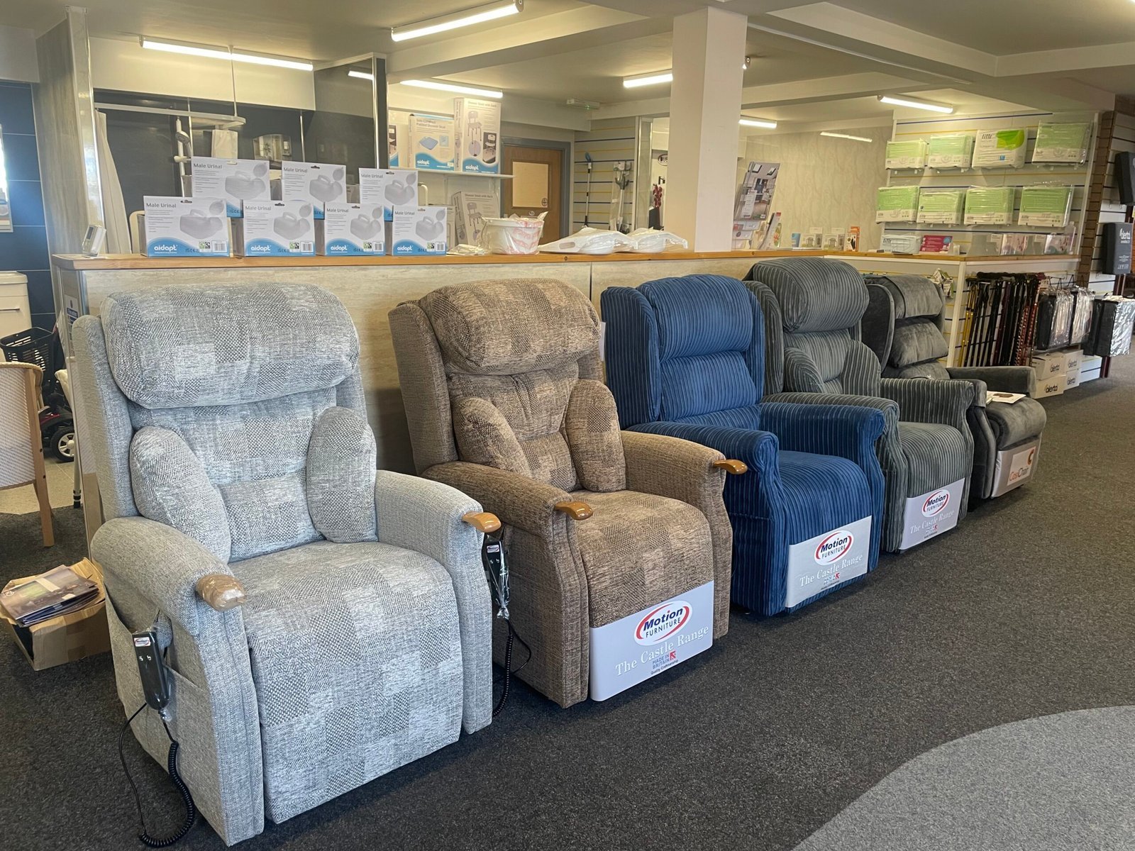 Row of riser recliner chairs on display in a Bush Healthcare showroom